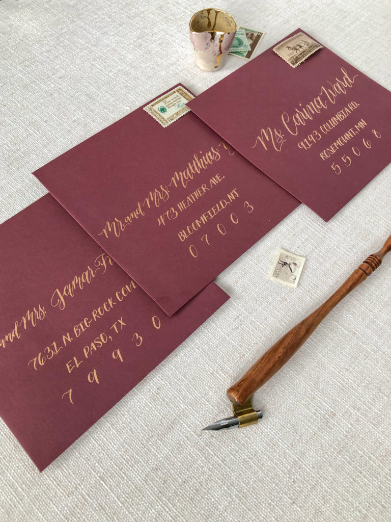 envelope calligraphy, burgundy envelopes with copper address and vintage stamps