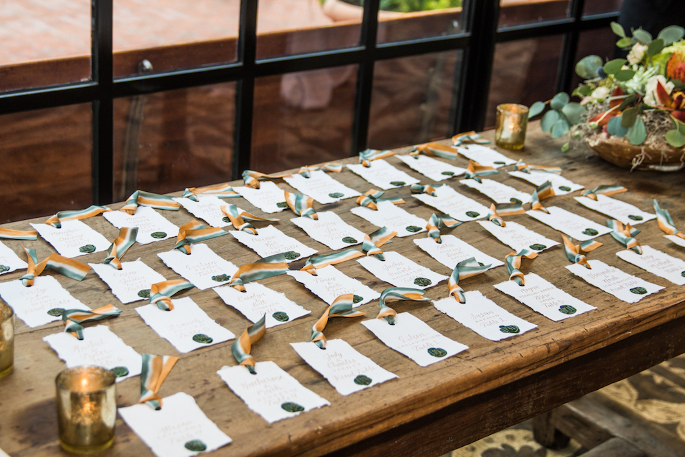 escort cards displayed on wooden table